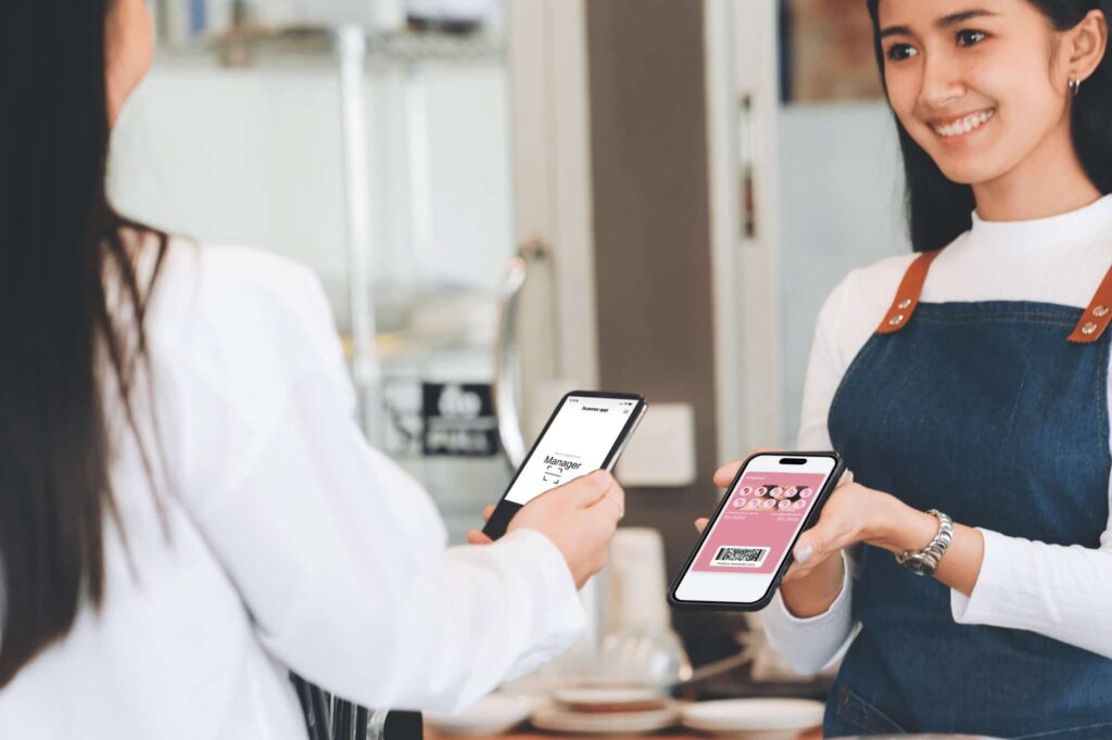 Digital Rewards Cards by Pixallus-rewards-card-customer-paying-through-mobile-phone-using-contactless-technology